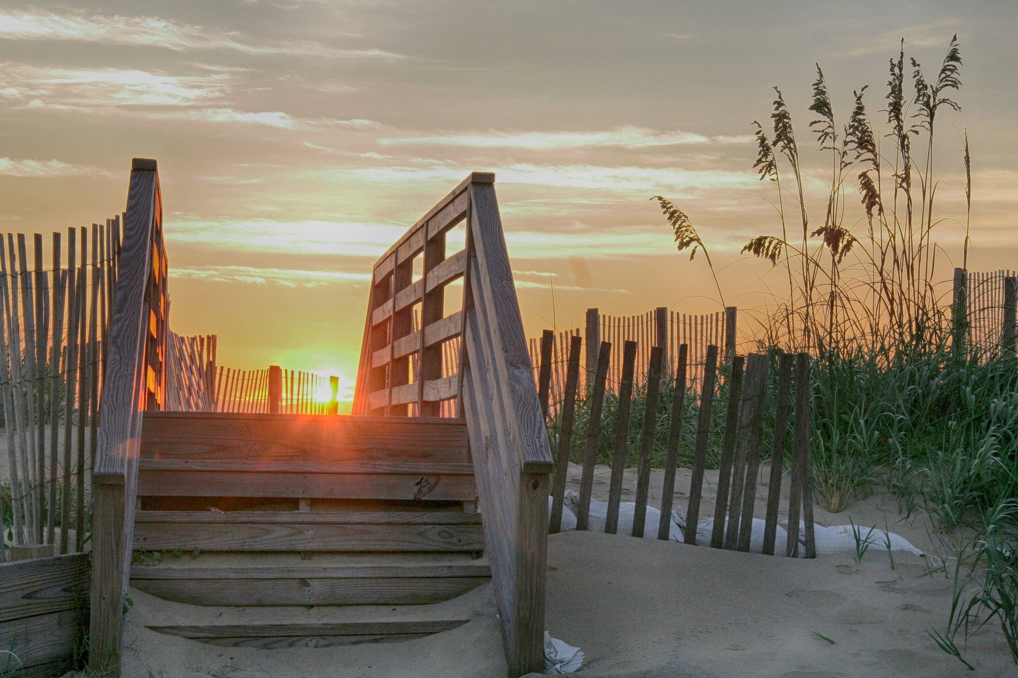 A wood path to the beach at sunrise in the Outer Banks, North Carolina